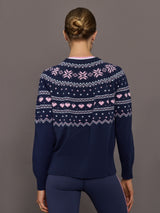 Back view of Fair Isle sweater showing pink heart and snowflake knit design.