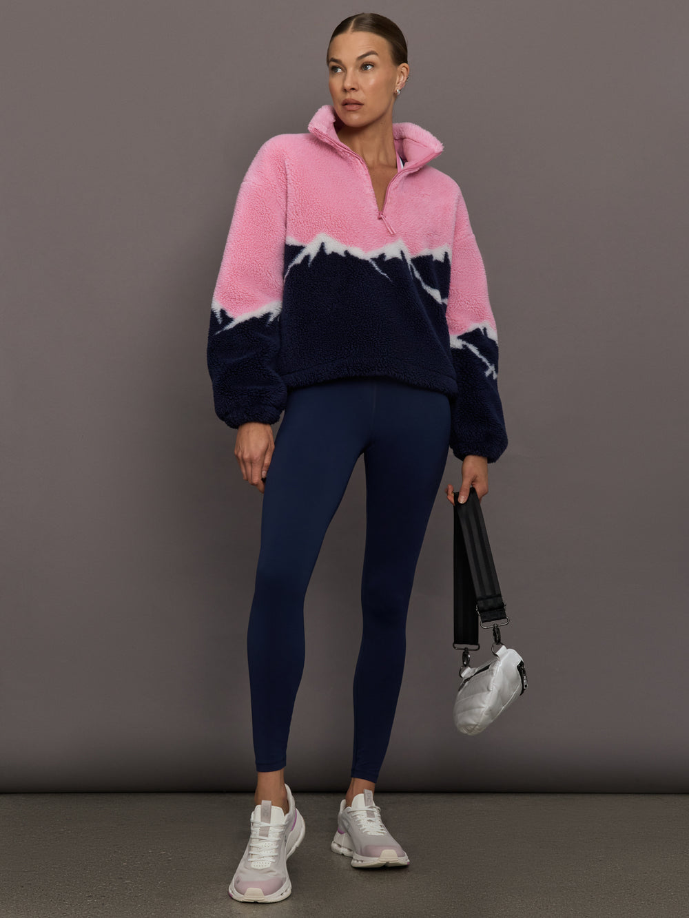 Full-length view of Lenoa Sherpa Top in Snowy Peaks styled with navy leggings.