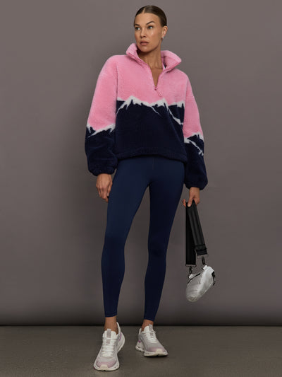 Full-length view of Lenoa Sherpa Top in Snowy Peaks styled with navy leggings.