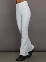 White bell-bottom pants worn by a person on a gray background