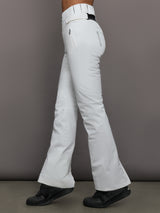 White snow pants worn by a person on a gray background