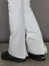 White pants with black shoes on a neutral background