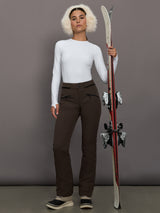 Person holding skis against a gray background