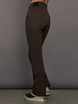 Brown ski pants worn by a person on a gray background