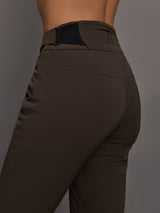 Brown pants worn by a person on a gray background