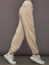 Side view of ILMI Sweatpants Dune showing tapered leg and pocket detail.