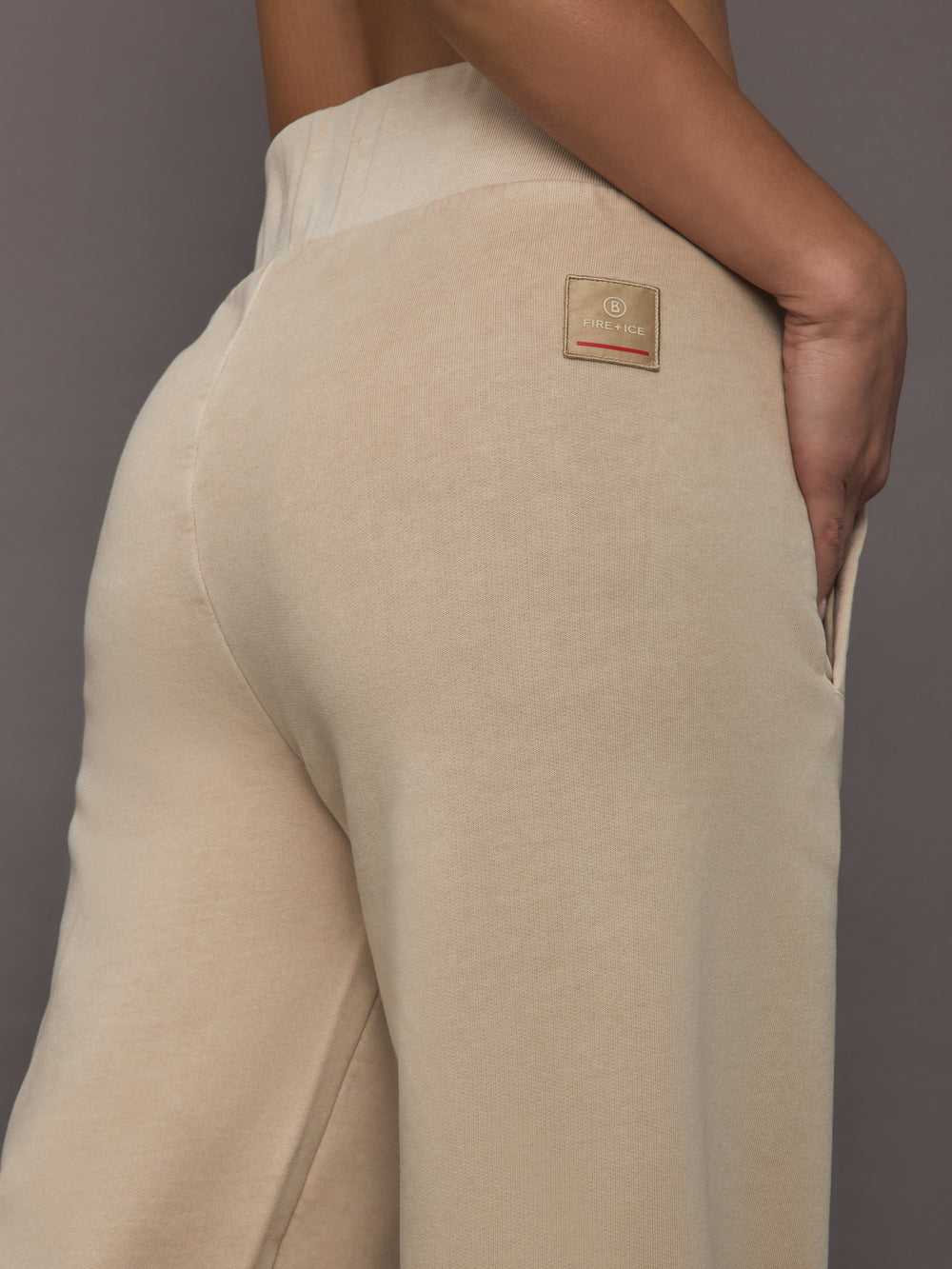 Close-up of ILMI Sweatpants Dune back waistband with Fire+Ice logo patch.