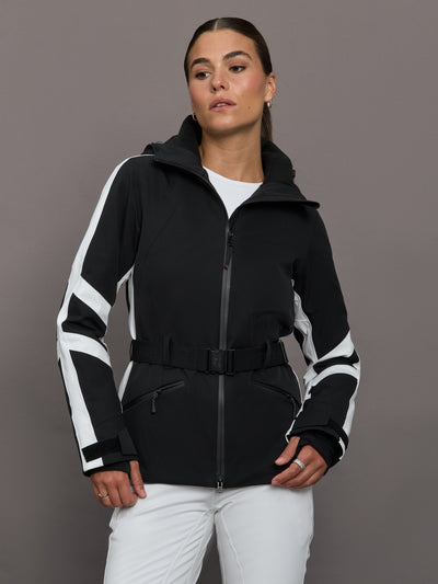 Person wearing a black and white ski jacket with a gray background