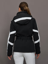 Person wearing a black jacket with white stripes on a gray background