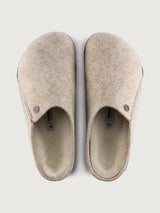 Pair of beige slippers on a white background