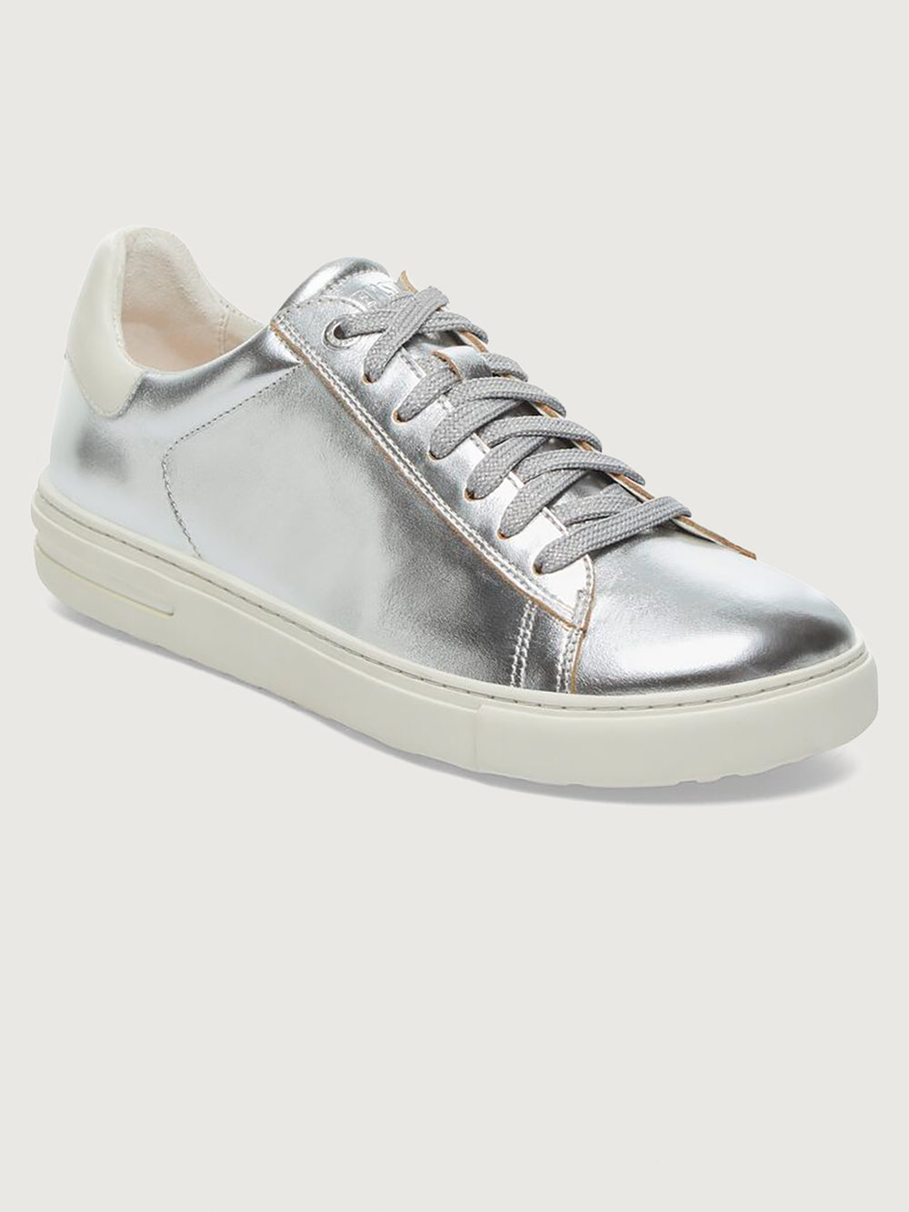 Silver sneaker with white sole.