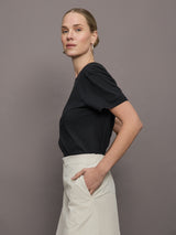 Model wears a basic black tee shirt with ringer neck and the word "Bandier" across the sleeve. 