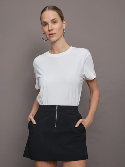 Model wears a basic white tee shirt with ringer neck and the word "Bandier" across the sleeve. 