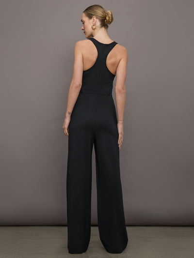 Model wears a black wide leg jumpsuit. 