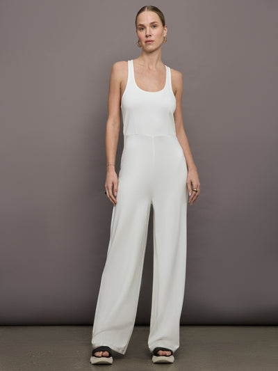 Model wears a white wide leg jumpsuit. 