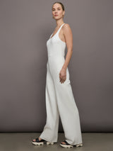 Model wears a white wide leg jumpsuit. 