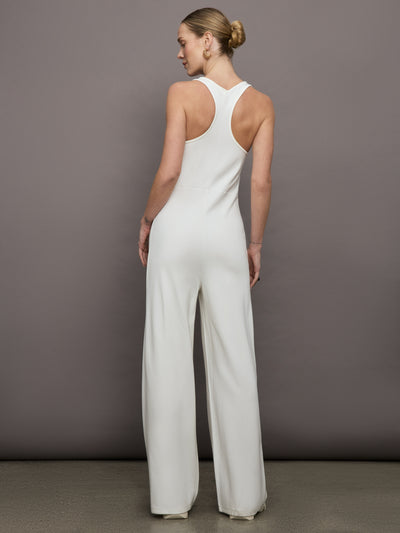 Model wears a white wide leg jumpsuit. 