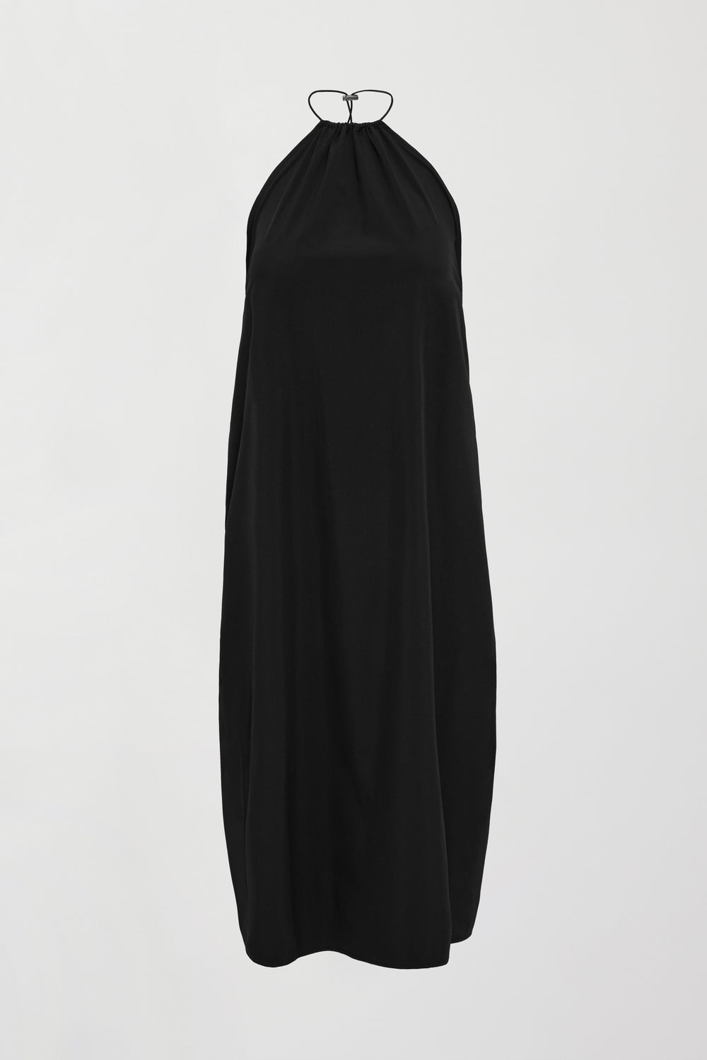 A loose fitting black dress with haltered neck that hits mid calf. 