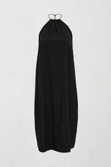 A loose fitting black dress with haltered neck that hits mid calf. 