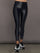 Model wears a mid rise waisted pair of liquidy shine black leggings that hit at model's mid to low calf.