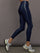 Model wears liquid takara shine leggings in regular rise with a thick waistband in navy.