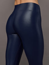 Model wears liquid takara shine leggings in regular rise with a thick waistband in navy.