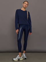 Model wears liquid takara shine leggings in regular rise with a thick waistband in navy.