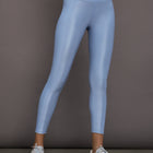 Model is wearing the High Rise 7/8 Legging in Takara Shine in Serenity shown from the front.