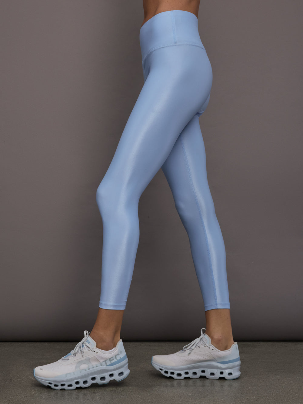 Model is wearing the High Rise 7/8 Legging in Takara Shine in Serenity shown from the side.