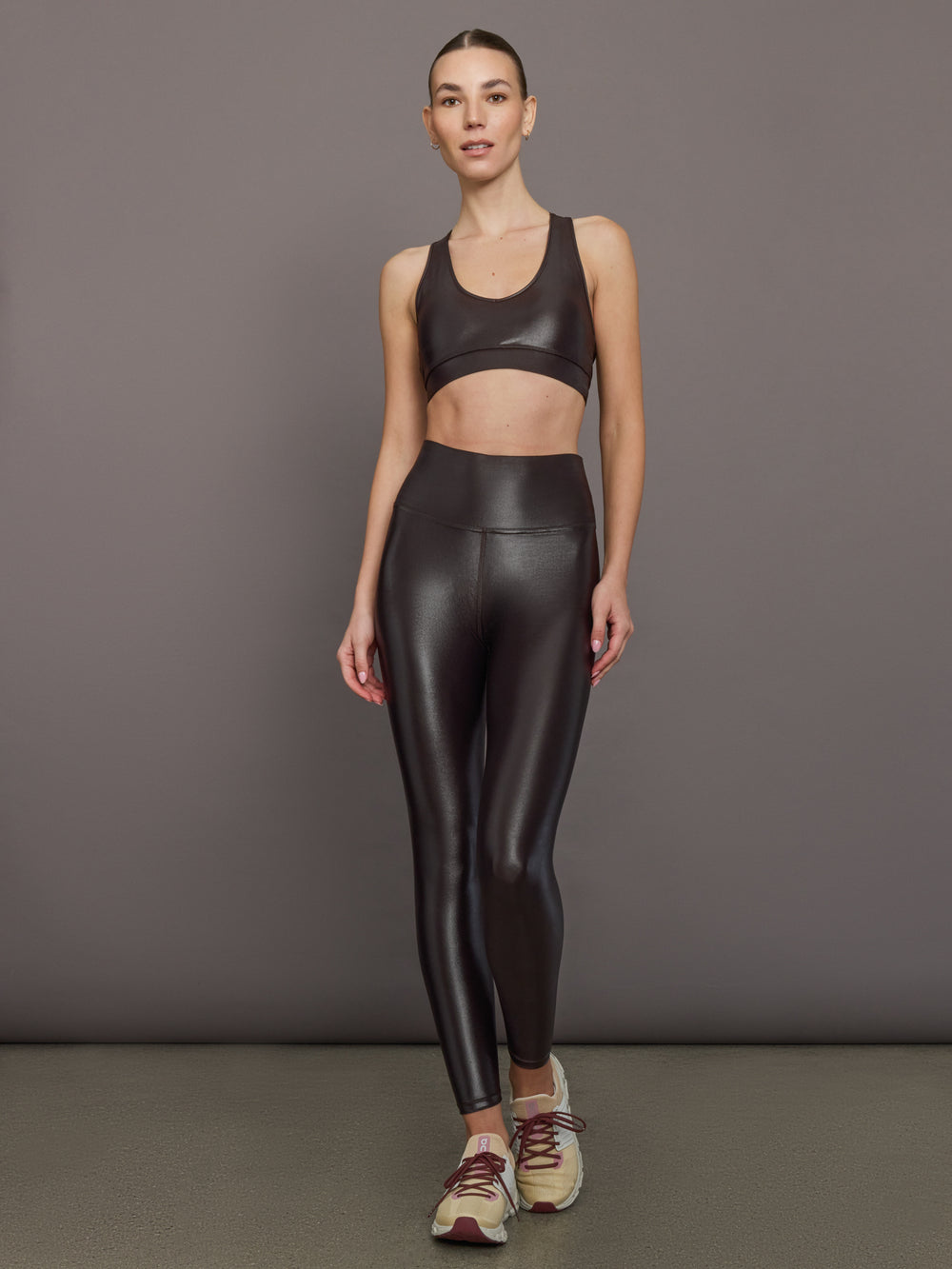 Model wearing High Rise 7/8 Legging in Takara Shine in Chocolate Torte styled with matching Action Bra.