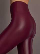 Close-up detail of High Rise 7/8 Legging in Takara Shine in Fig highlighting glossy finish and sculpting waistband.
