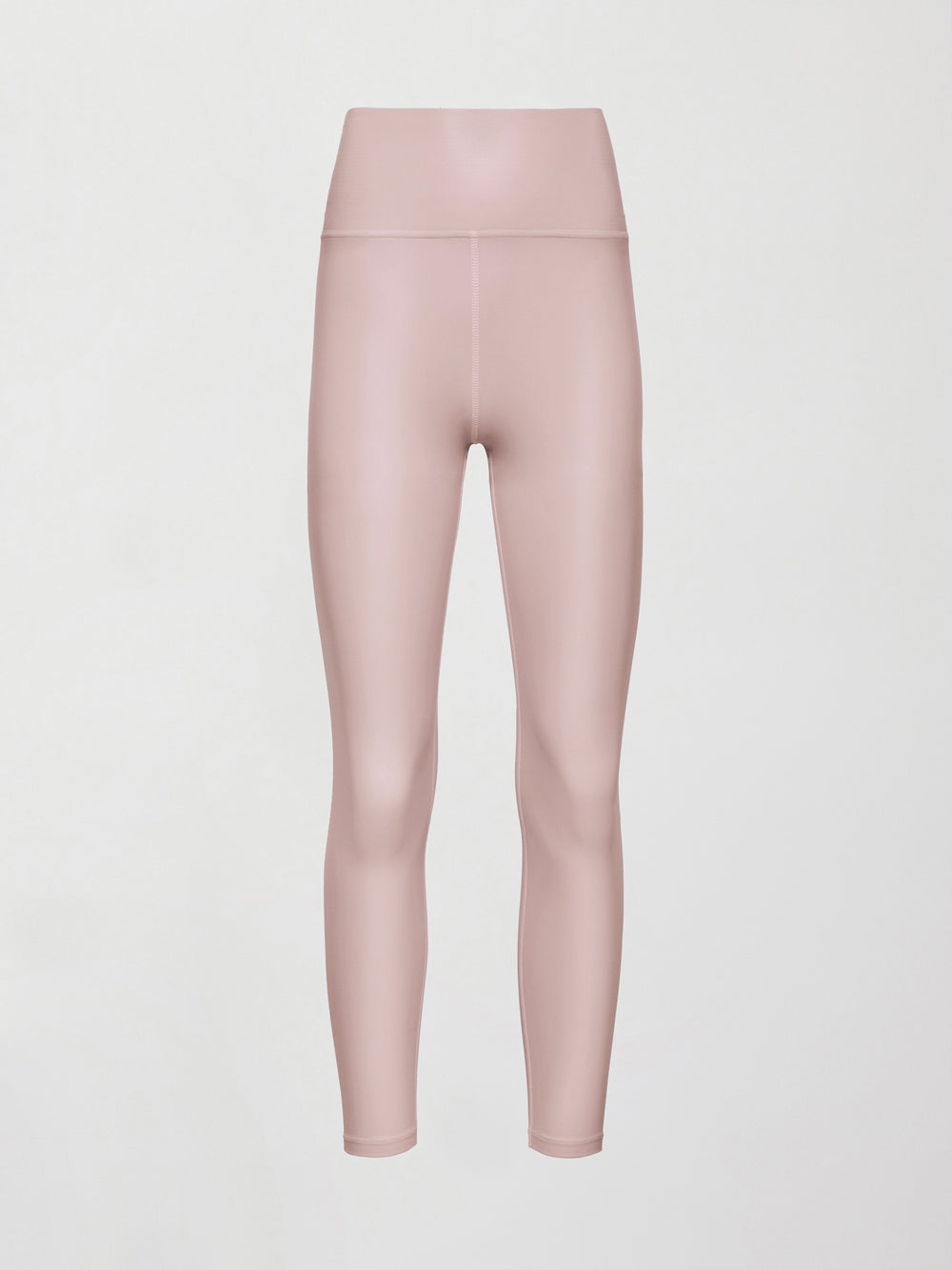 Model wears a pair of high rise baby pink sleek liquidy shine leggings. 