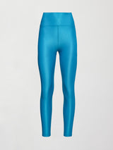 Model wears high rise, liquidy fabrication with crocodile texture, bright blue leggings. 