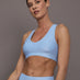 Model is wearing the Action Bra 2.0 in Takara Shine in Serenity shown from the front.