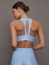 Model is wearing the Action Bra 2.0 in Takara Shine in Serenity shown from the back highlighting sculpted support.