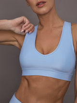Close up of the Action Bra 2.0 in Takara Shine in Serenity highlighting the V neckline.