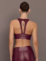 Back view of Action Bra 2.0 in Takara Shine in Fig with racerback straps and cutout detail, paired with matching leggings.