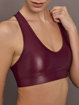 Close-up of Action Bra 2.0 in Takara Shine in Fig highlighting glossy Takara Shine fabric and scoop neckline.