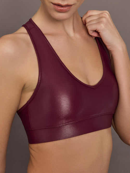 Close-up of Action Bra 2.0 in Takara Shine in Fig highlighting glossy Takara Shine fabric and scoop neckline.