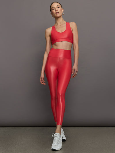 Model wears a v neck bright red bra in a liquidy takara shine finish. 