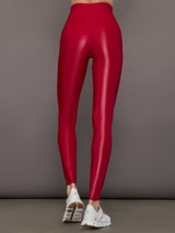 Model wears a shiny high waisted bright red pair of leggings with a thick, flattering waistband. 