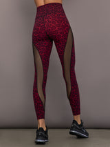 Model is wearing Melt sheer spliced leggings in red leopard, back view.