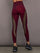 Model is wearing Melt sheer spliced leggings in red leopard, back view.
