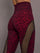 Model is wearing Melt sheer spliced leggings in red leopard, close-up waistband and print.