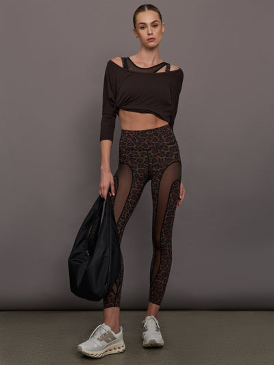 Model wearing Leopard print leggings with sheer panels