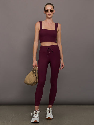 Model wearing Fig colored leggings with a high waist and pockets