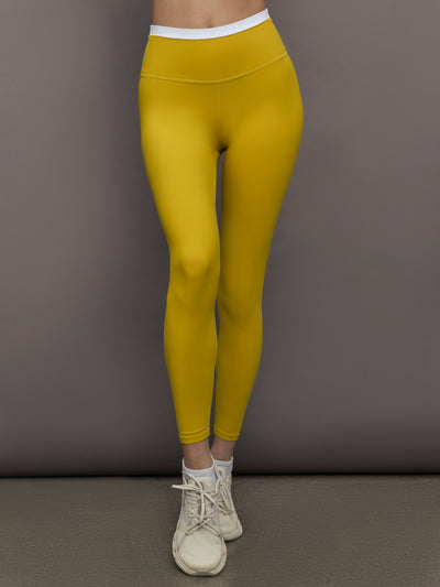 Model is wearing Melt contrast waistband legging in Mango Mint/White, front view.