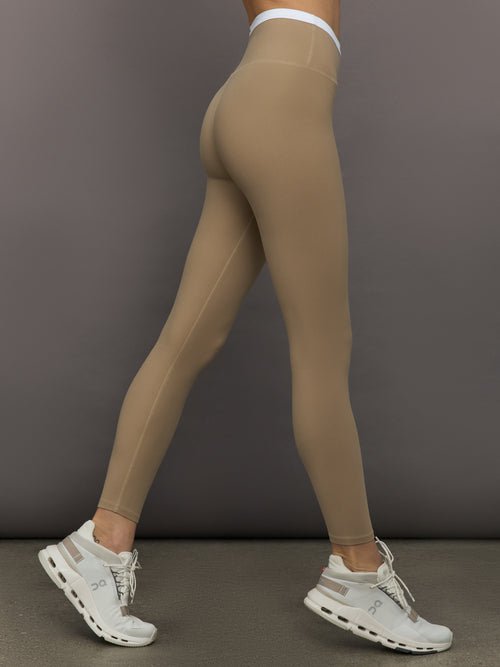 Model wears a buttery soft high waisted chinchilla legging with thin white waistband. 