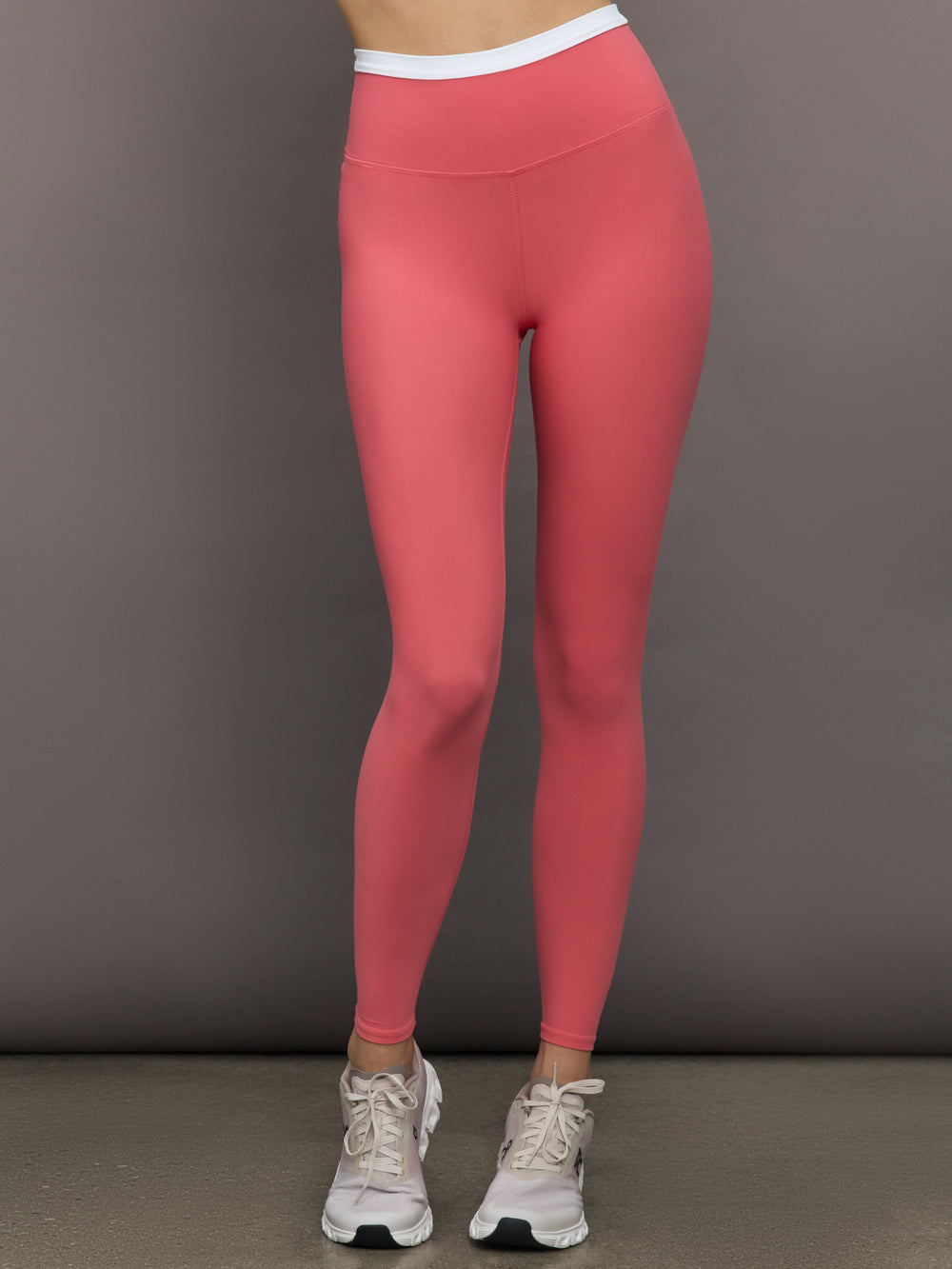 Model wears a buttery soft high waisted rosewood legging with thin white waistband. 