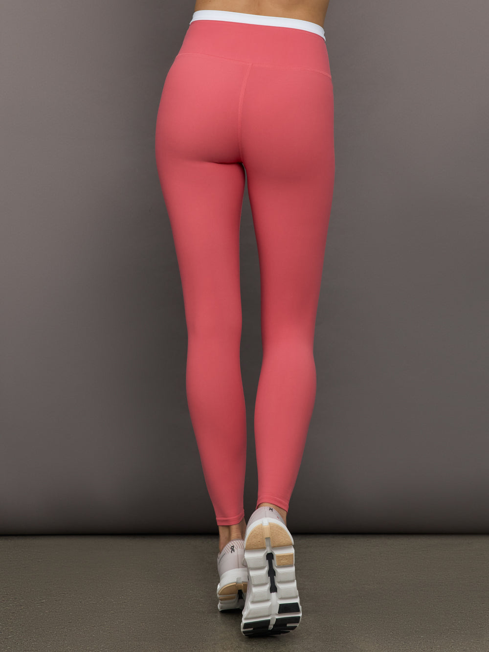 Model wears a buttery soft high waisted rosewood legging with thin white waistband. 